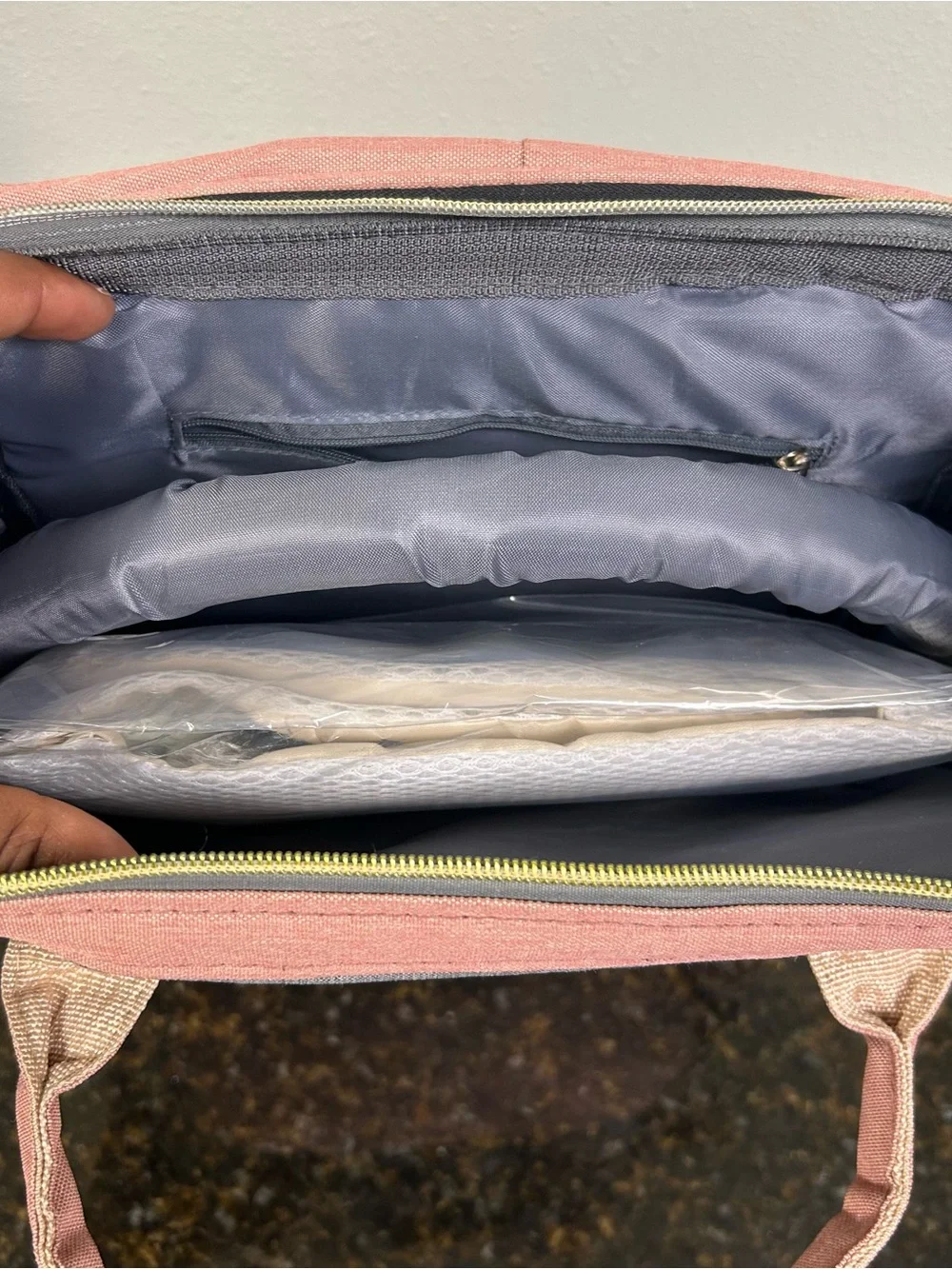 LAND Traveling Share diaper bag backpack in a pink and gray color scheme